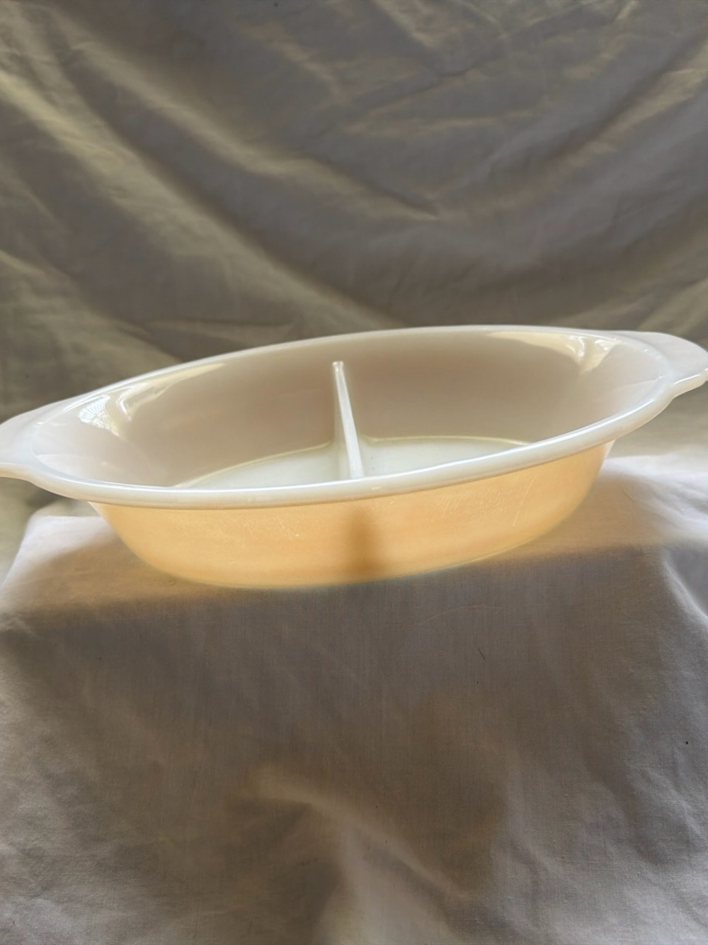 VTG fire-king divided casserole dish in the peach luster finish